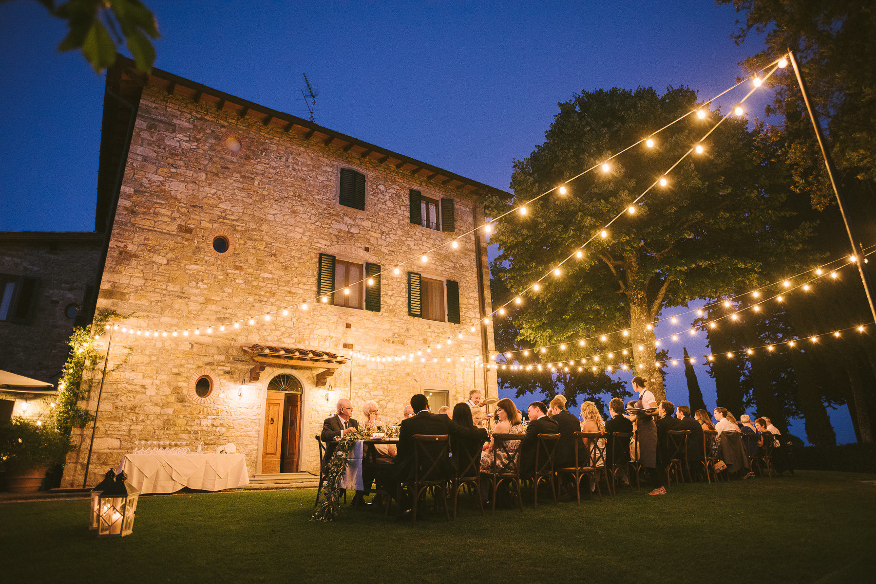 Unforgettable wedding dinner under lovely lights in Tuscany countryside in Chianti near Panzano