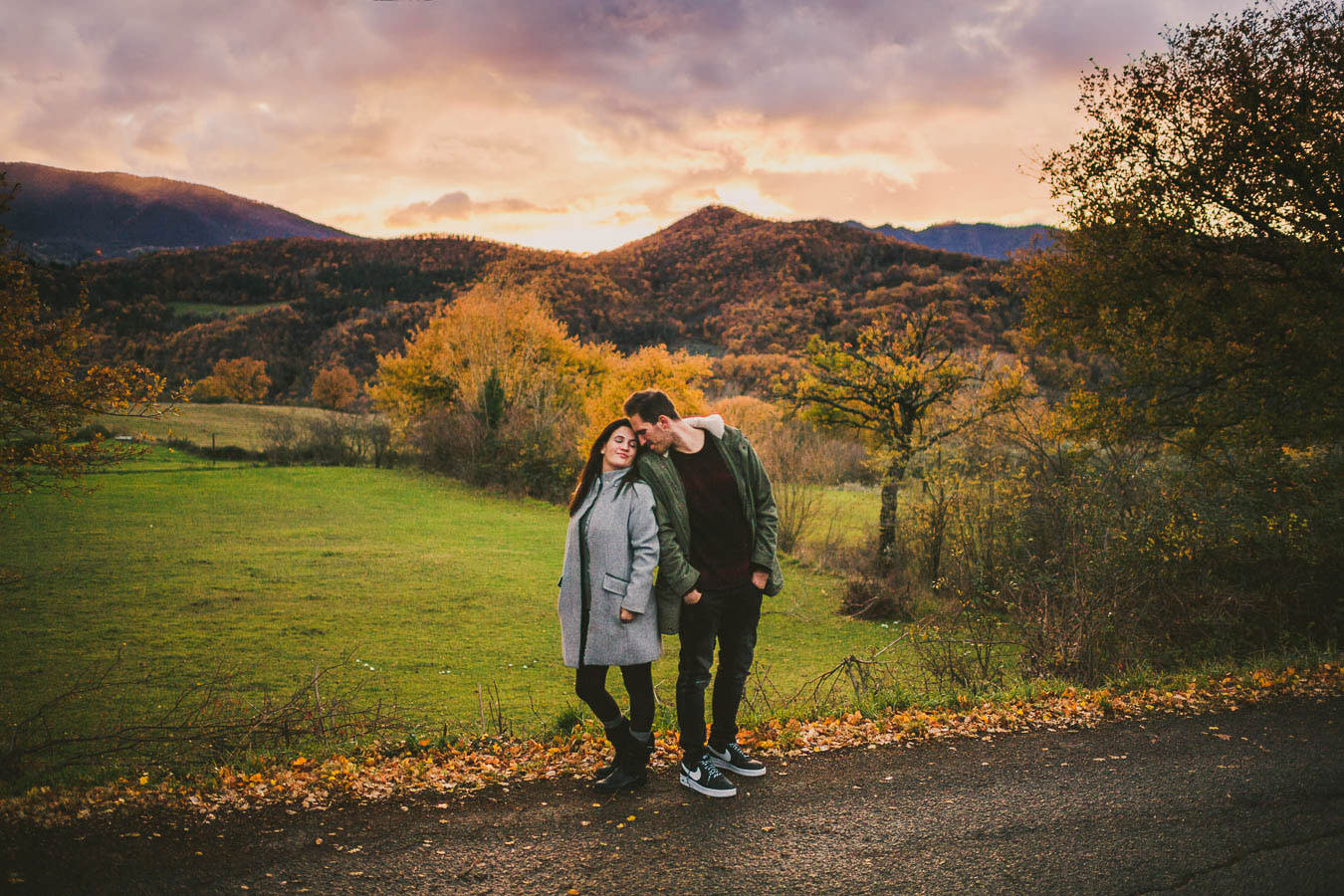 Beautiful engaged couple photo with the gorgeous sunset view of Tuscany countryside in Mugello near Florence