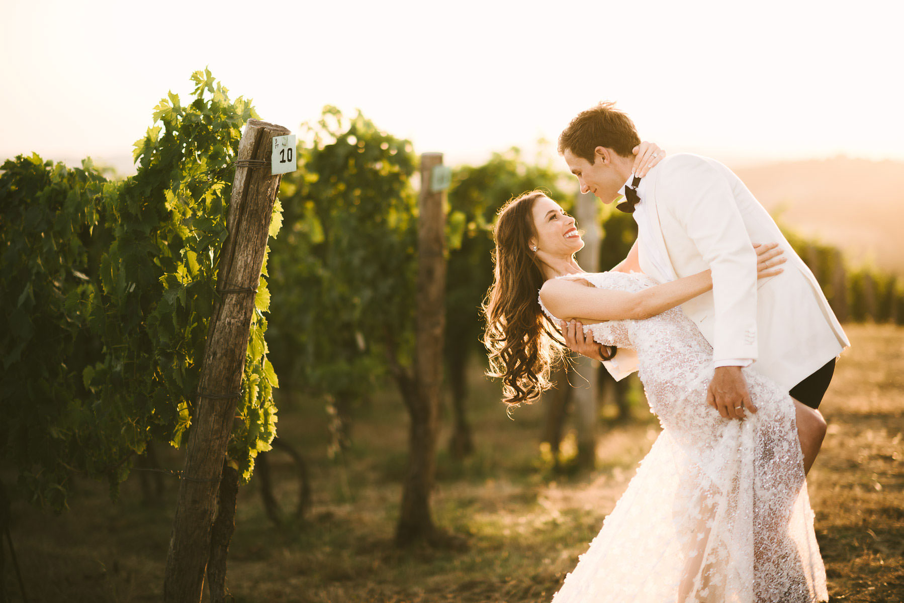 Unforgettable bride and groom portrait in a Tuscan vineyard near Panzano for destination wedding agriturismo near Panzano in Chianti
