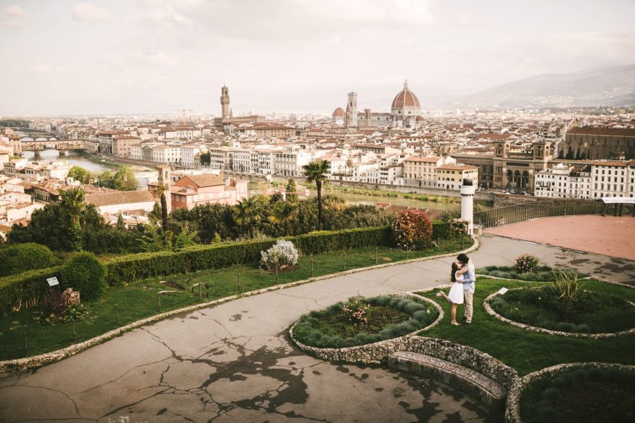 Romantic couple portrait panoramic photo at Piazzale Michelangelo, Florence at sunrise time with no tourists