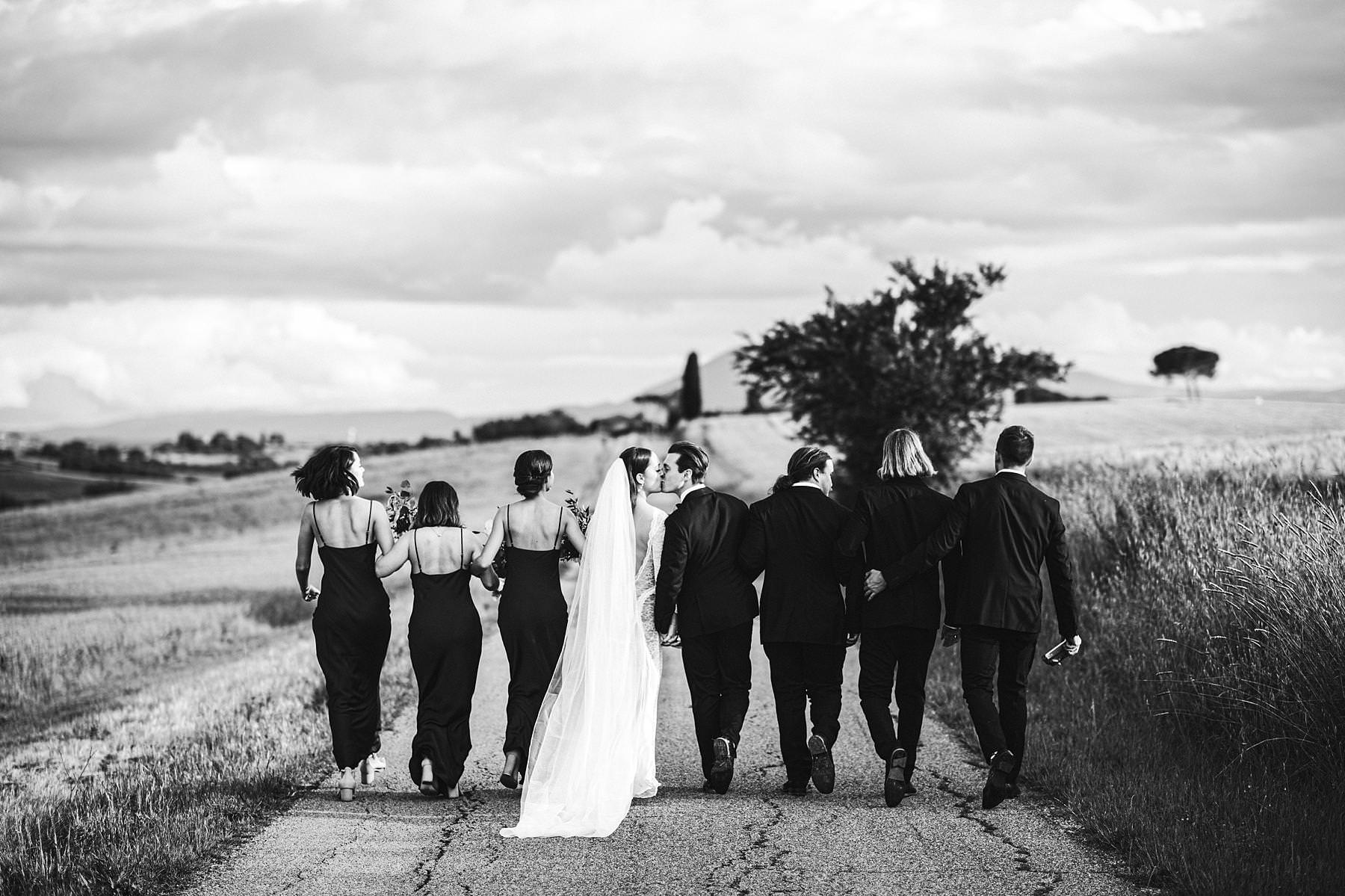 Romantic bridal party wedding photo in the countryside of Umbria with corn field as the background. Intimate destination symbolic wedding day at incredible historic venue Villa l’Antica Posta
