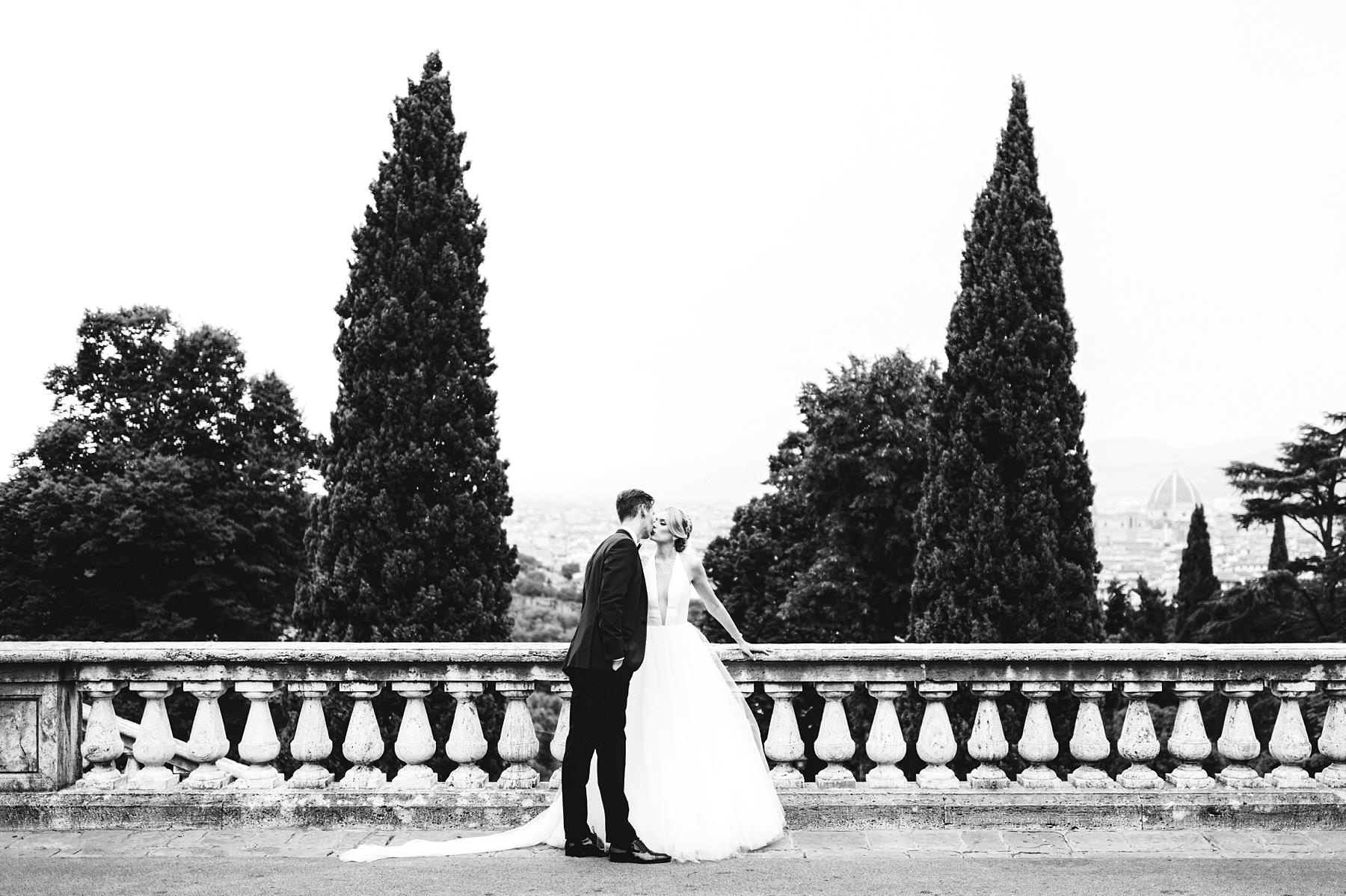 Lovely wedding photo of bride Christina in her Liancarlo wedding gown with a golden tiara which make her a real princess with groom Cheyne in his bespoke tuxedo. Intimate luxury destination wedding in Florence at Villa La Vedetta