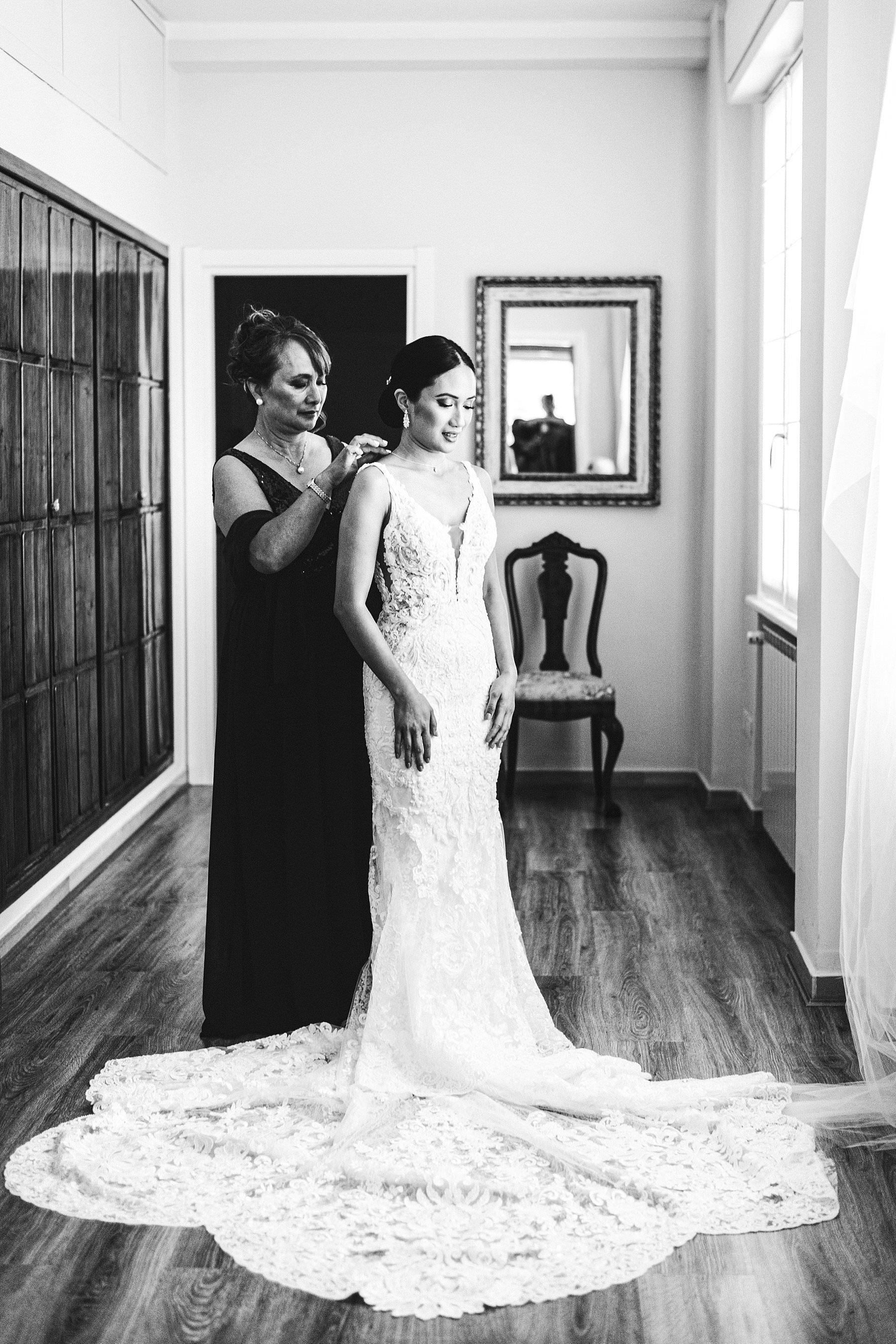 Beautiful moment with mom and bride Liza in her luxury Martina Liana wedding gown during getting ready. Intimate destination wedding in Florence