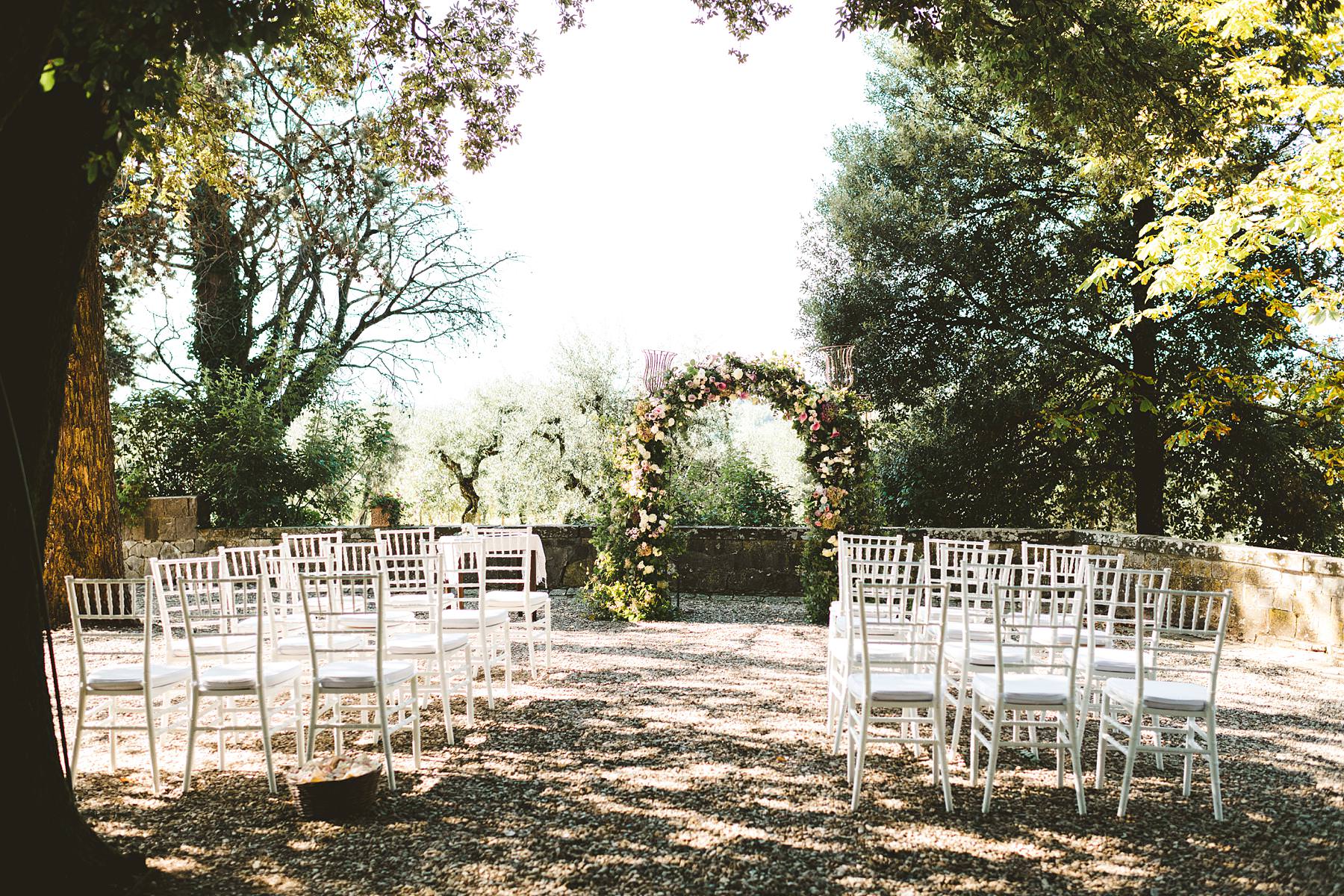 Outdoor wedding ceremony decor in the park of Castello Il Palagio