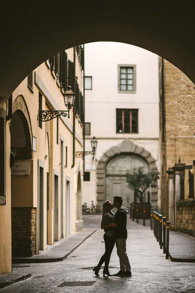 Engaged couple walks into Florence street for pre-wedding photo shoot