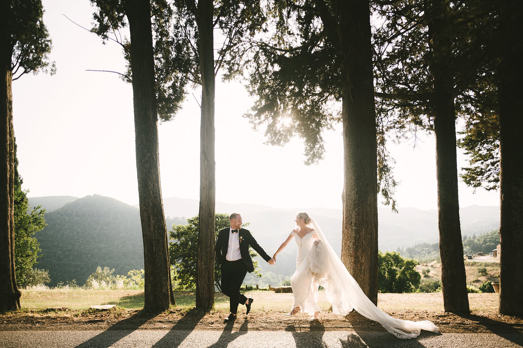 Romantic wedding in Italy at the charming Castello del Trebbio. Exciting and fun bride and groom portrait session during intimate destination wedding in the countryside of Tuscany