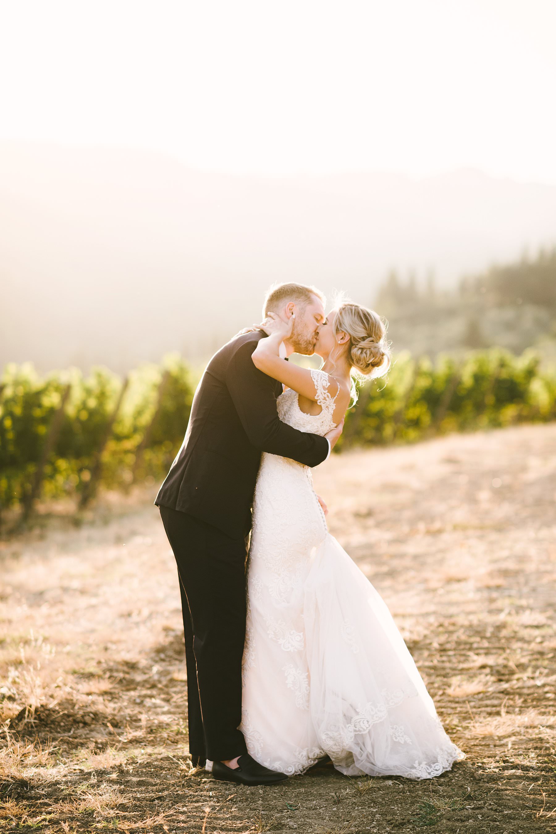 Romantic wedding in Italy at the charming Castello del Trebbio. Dreamy and unforgettable bride and groom wedding portrait during golden hour in the vineyard of the countryside of Tuscany at Castello del Trebbio