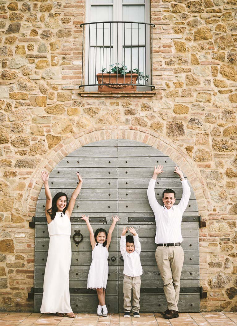 Exciting and fun summer family vacation photo shoot in Tuscany countryside. Mom, dad and kids are enjoying some time during the photo session