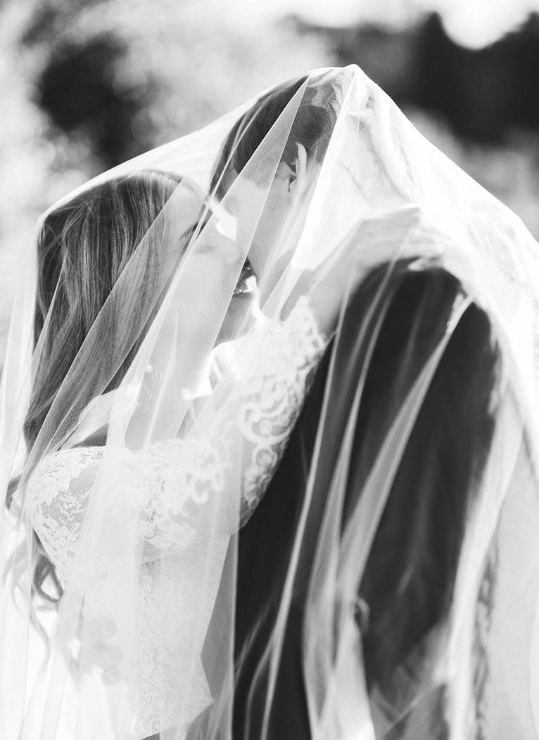 Timeless bride and groom wedding photo under Tuscan sun in Chianti vineyard near Villa Mangiacane