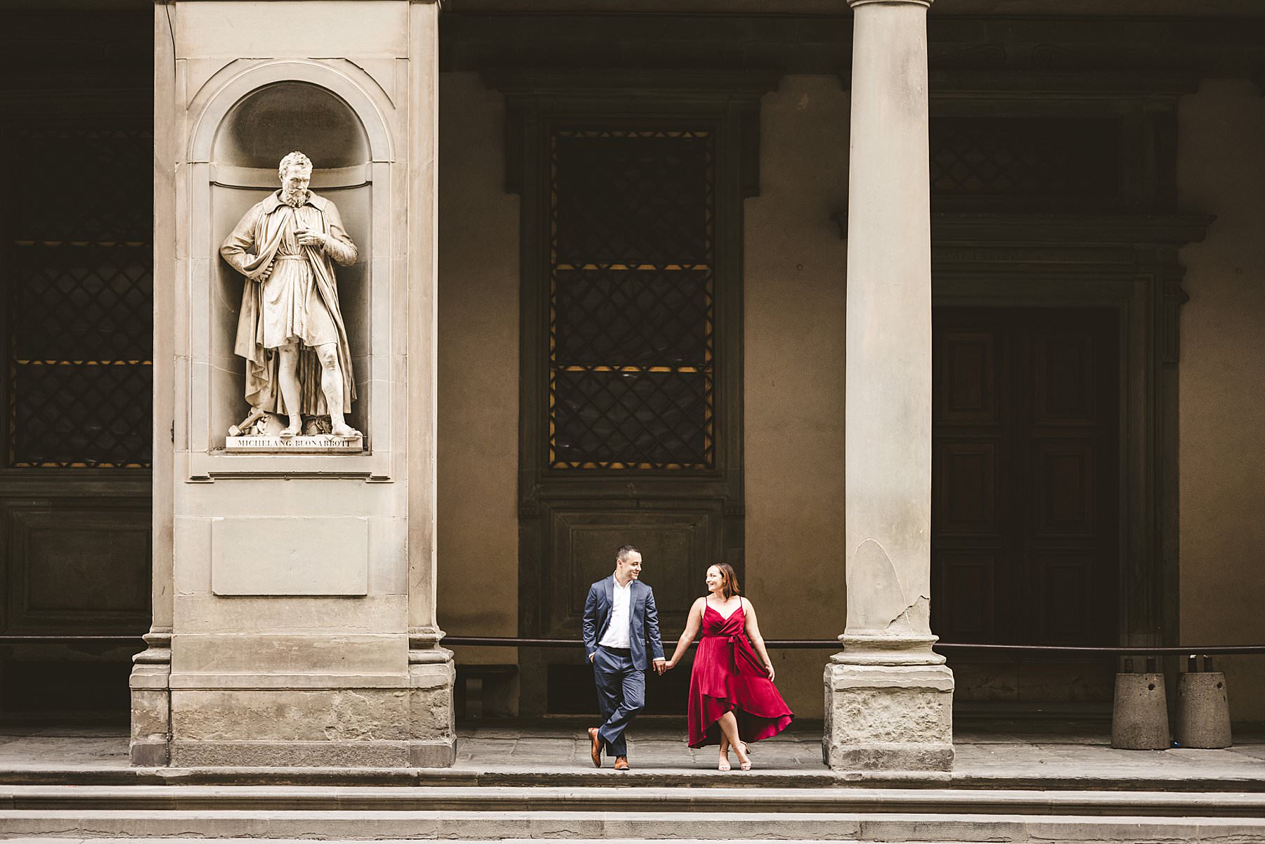 Exciting couple portrait pre-wedding photo shoot in the Uffizi Art Gallery located in the heart of Florence, Tuscany