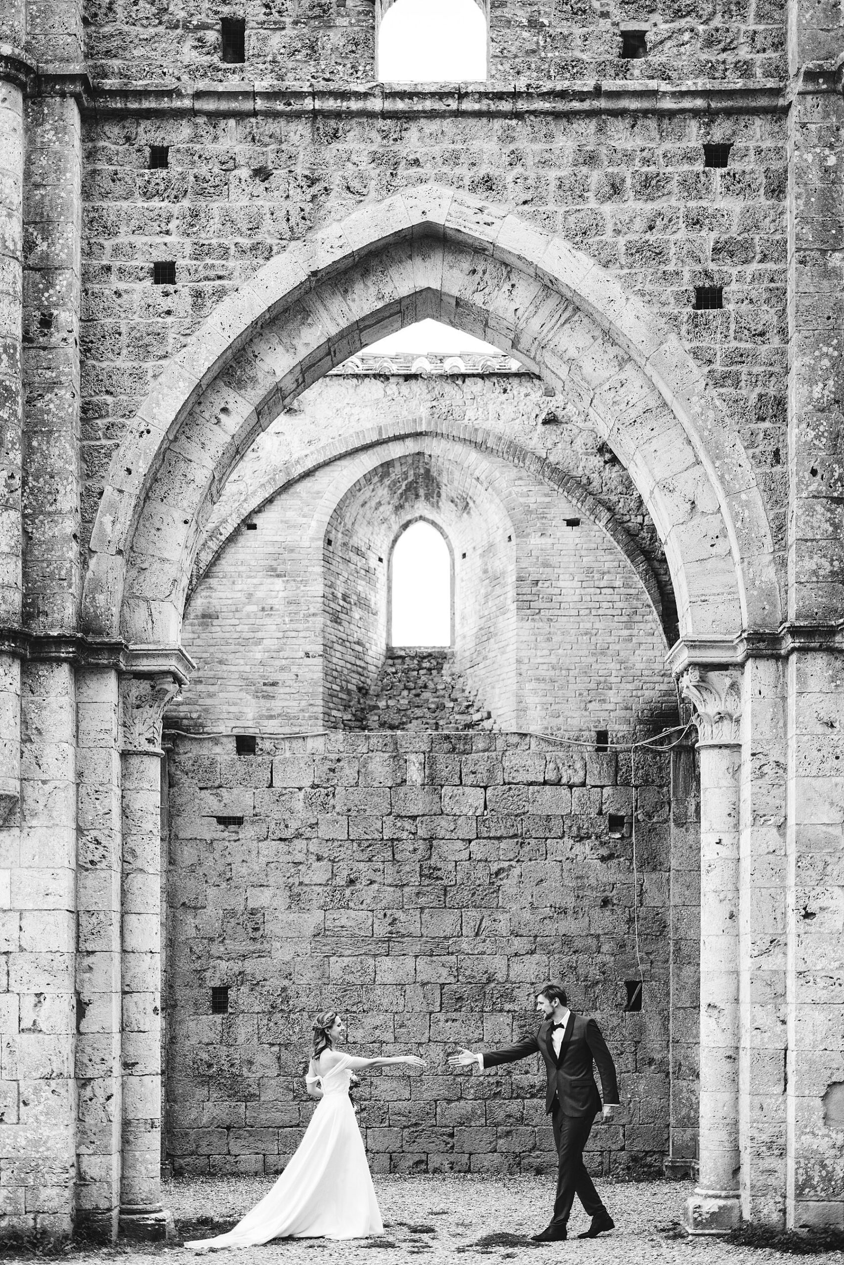 Exciting and elegant couple portrait wedding photo session inside the San Galgano Abbey