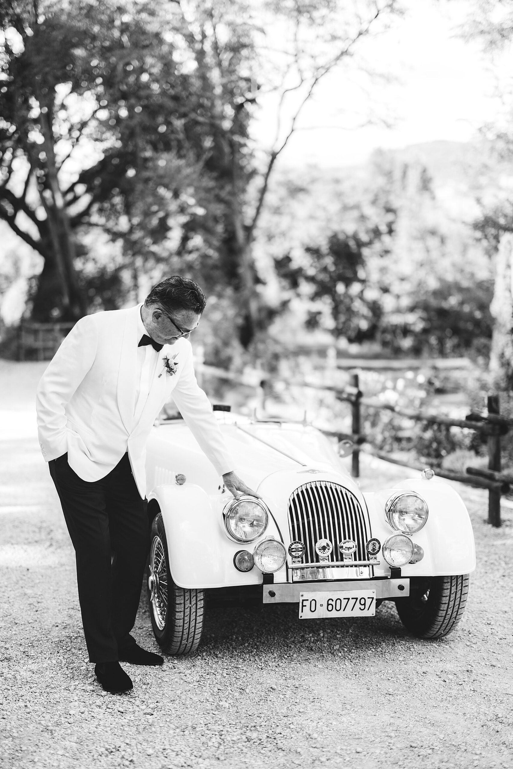 Morgan vintage car at Borgo Pignano private villa with groom for timeless elopement wedding in the heart of Tuscany