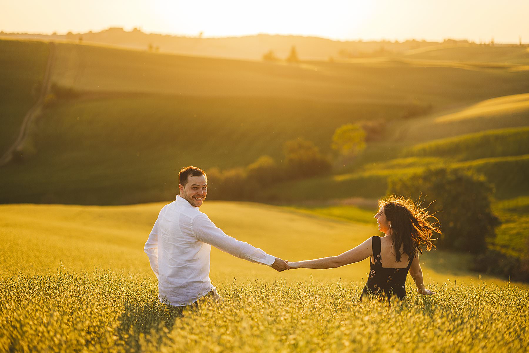 Pre wedding couple shoot in the evocative golden hour of the countryside of Tuscany Val d’Orcia near Pienza