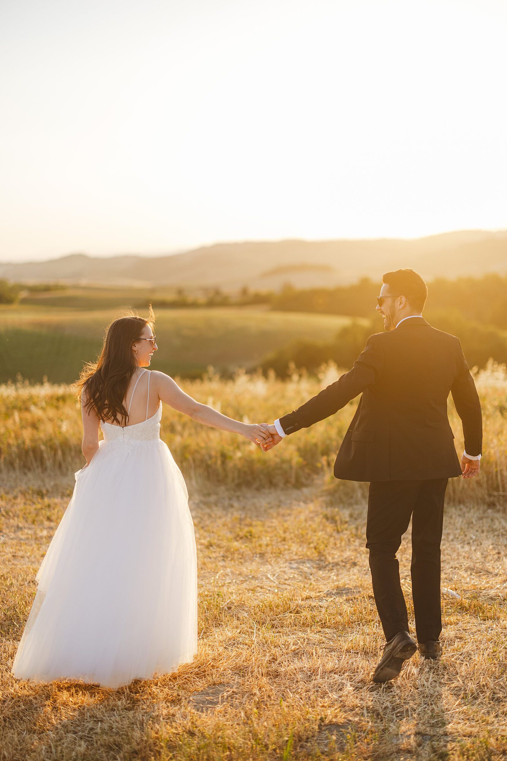 Bride and groom wedding portrait in the golden hour light heart of Val d’Orcia near Pienza