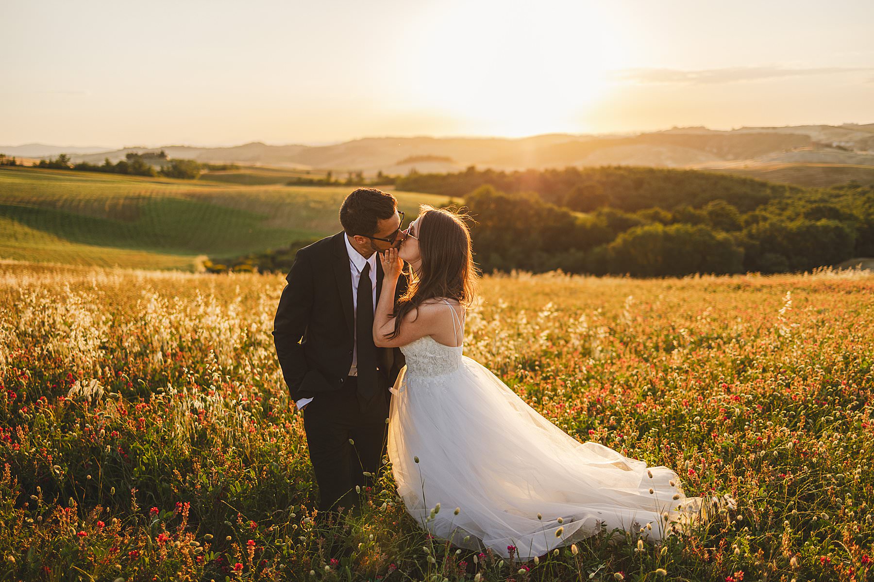 Exciting bride and groom elopement wedding portrait in the golden hour light in the heart of Tuscany countryside near Pienza