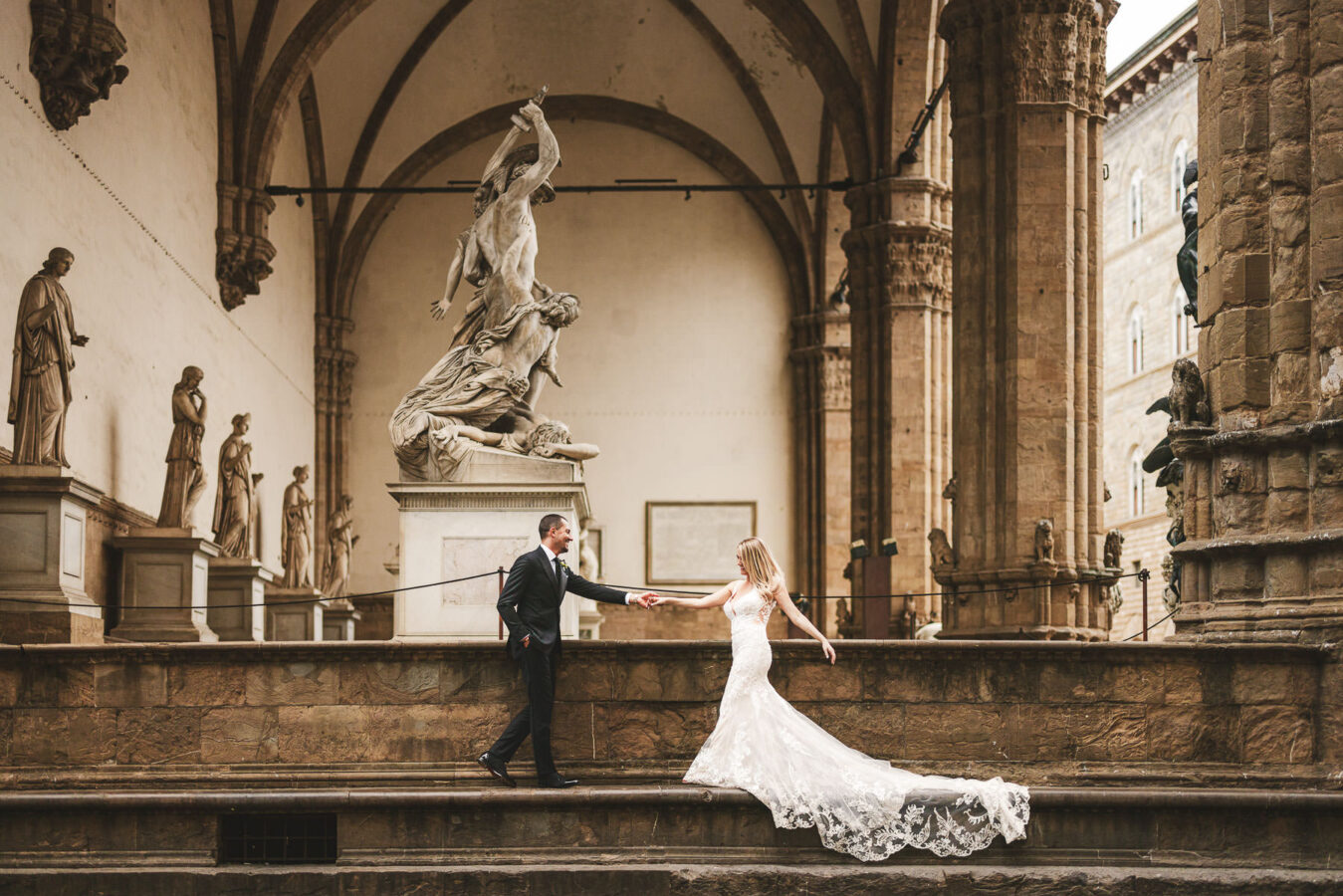 A unique setting for a unique celebration. Bride and groom elopement photo at Loggia de Lanzi near Uffizi Gallery in Florence