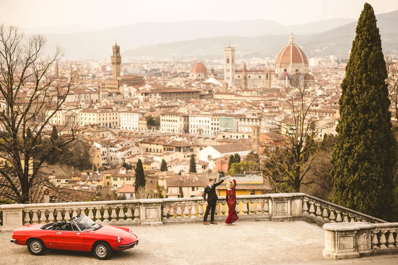 Wedding vow’s renewal anniversary photos in Florence with bright-red Alfa Romeo spider an unforgettable celebration