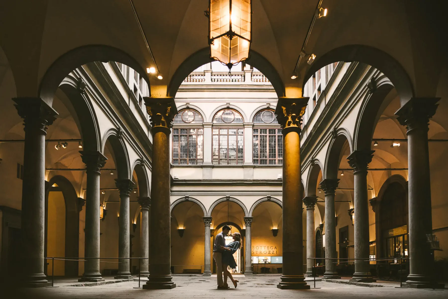 Lovely and elegant engagement photo at sunrise early morning in Florence at Palazzo Strozzi