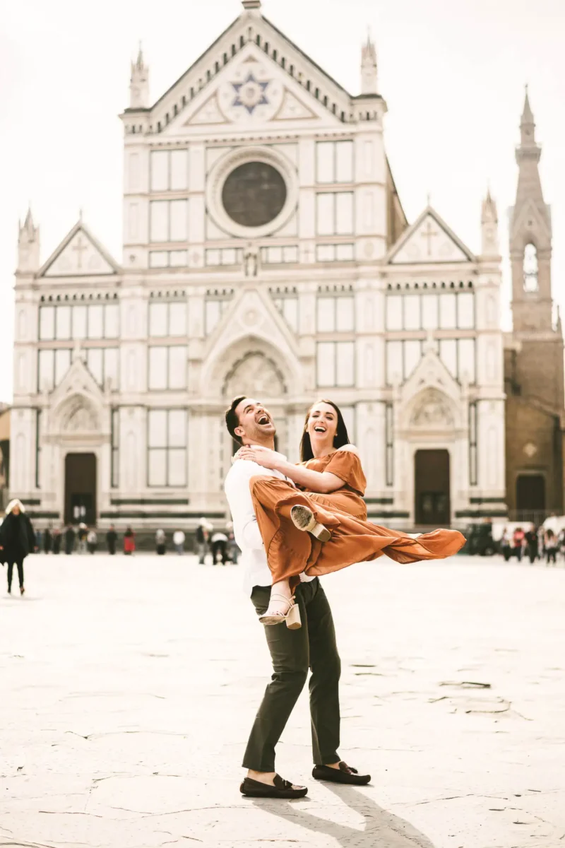 Lovely couple portrait at Santa Croce square in the heart of Florence at sunrise time