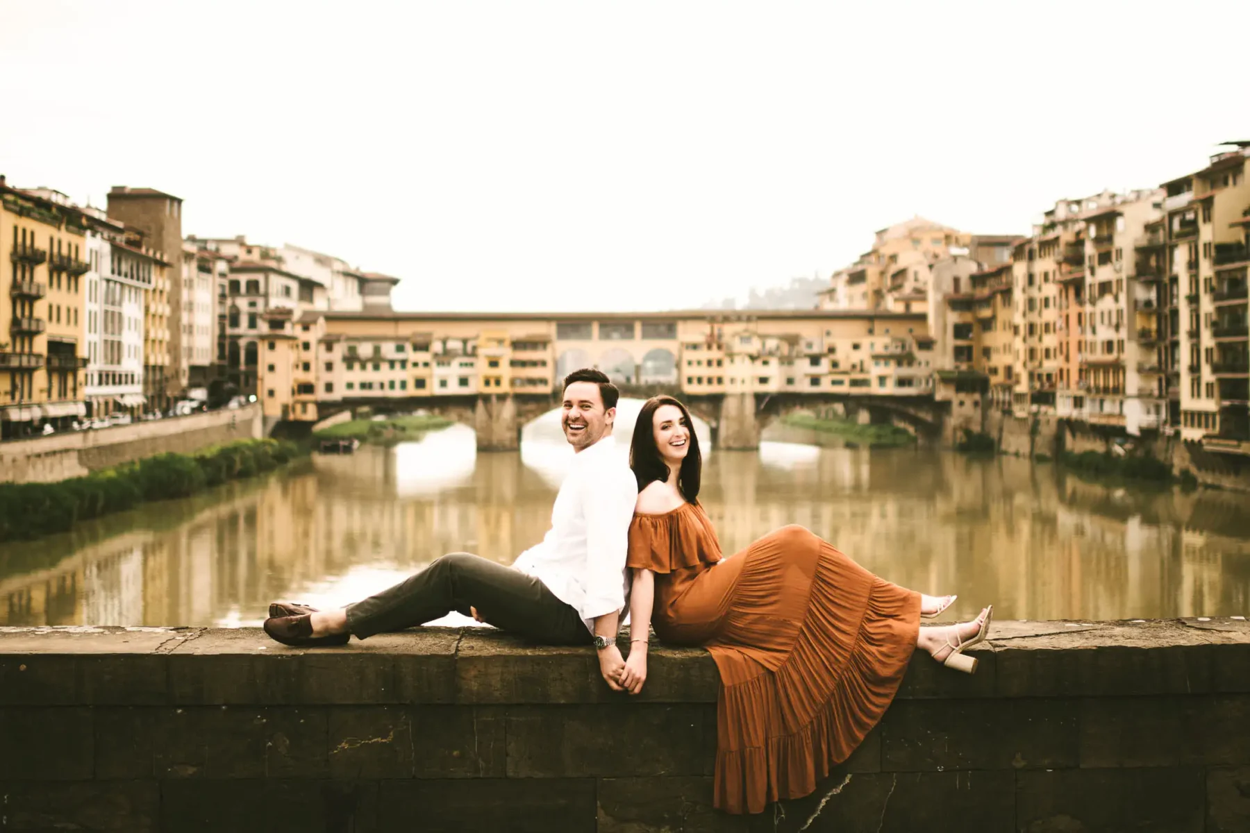 Creative and fun couple engagement photo shoot near Old Bridge in Florence. Sunrise photo session with no tourists down the streets