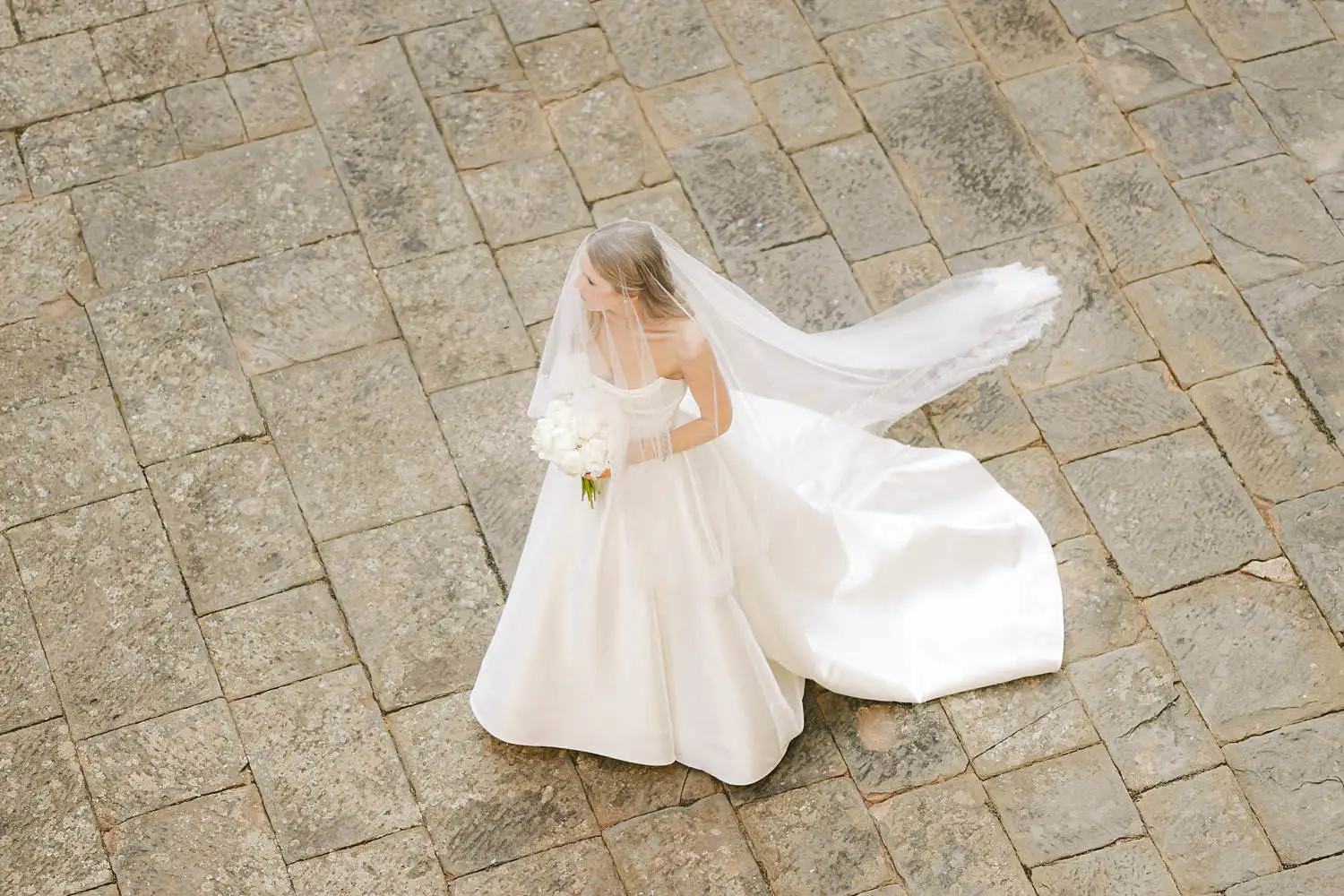 Elegant bride in wedding gown awaiting for the walk of the aisle at Castello di Celsa luxury wedding