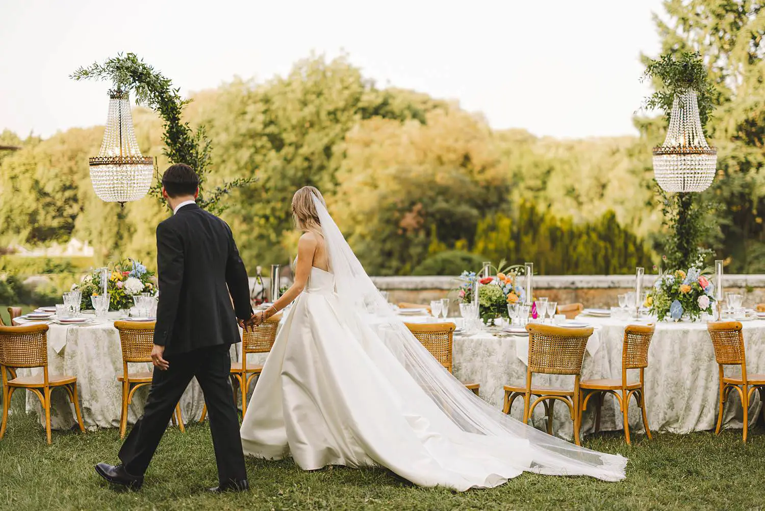 Bride and groom are enjoying their reception wedding dinner table at Castello di Celsa in the countryside of Tuscany