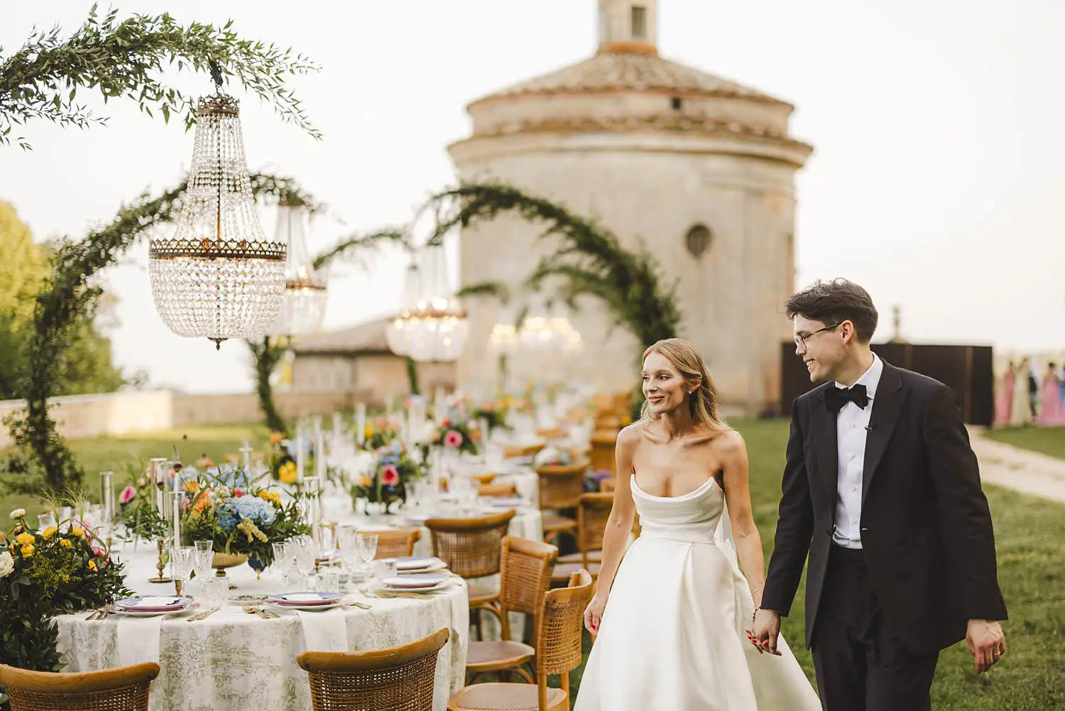Bride and groom are enjoying their reception wedding dinner table at Castello di Celsa in the countryside of Tuscany