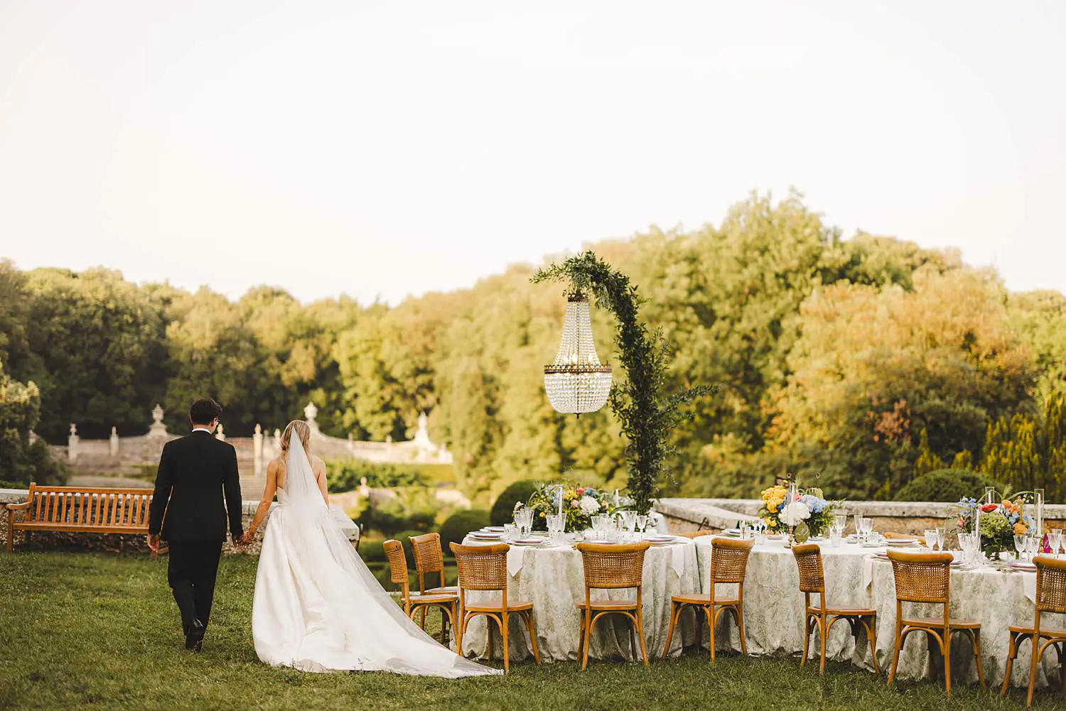 Bride and groom are enjoying their reception wedding dinner table at Castello di Celsa in the countryside of Tuscany