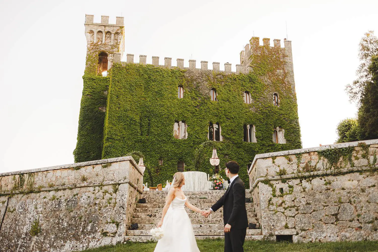 Bride and groom are admiring the luxury and breathtaking venue of their wedding at Castello di Celsa