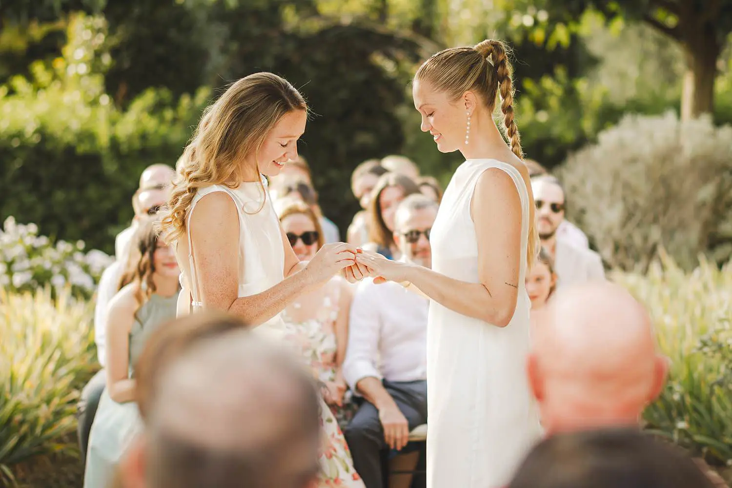 Borgo di Petrognano outdoor same sex wedding ceremony among a natural archway of greenery, with guests seated close, creating an atmosphere that felt warm and deeply connected