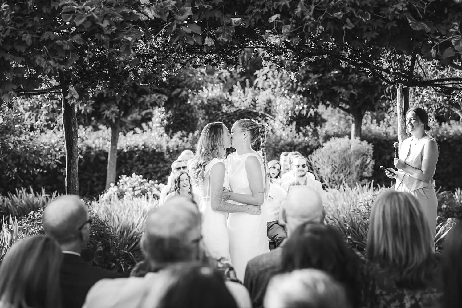 Same sex wedding joyful first kiss during heartfelt outdoor intimate ceremony at Borgo di Petrognano
