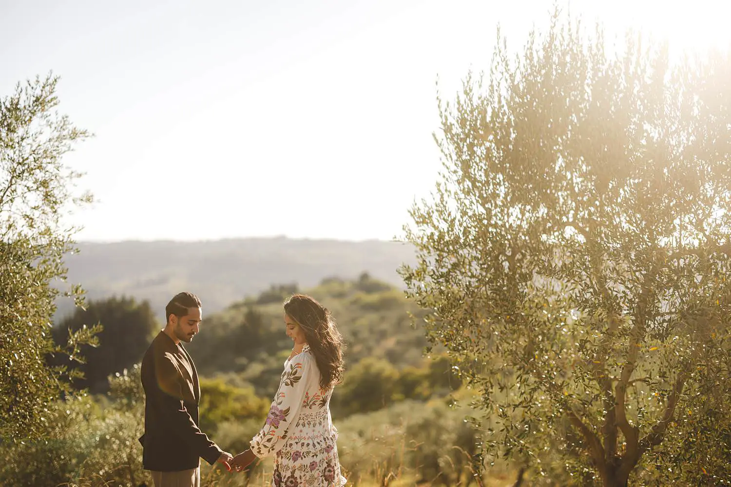 A golden Chianti countryside engagement among olive trees