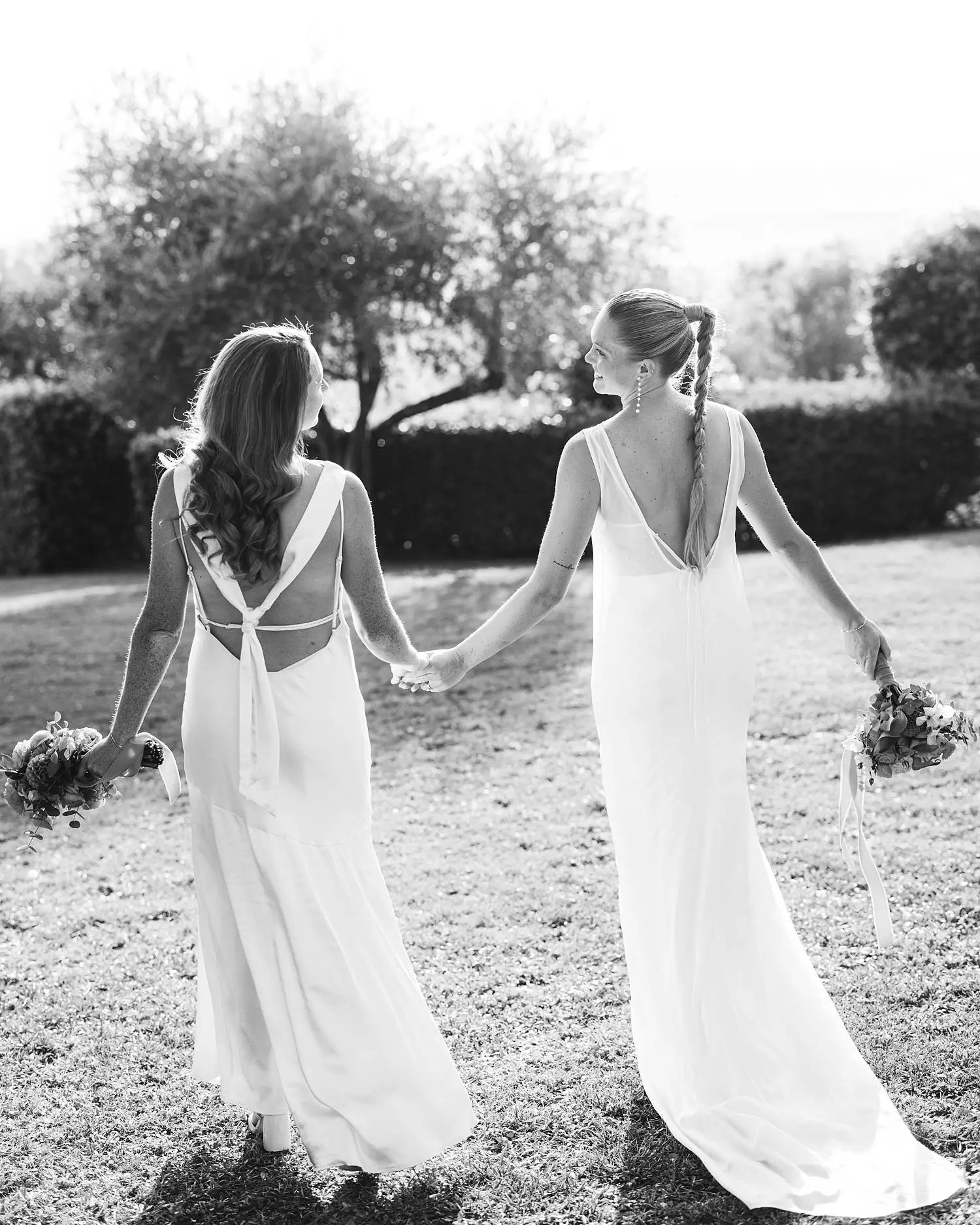 Lovely same sex brides wedding portrait while exploring gardens of Borgo di Petrognano