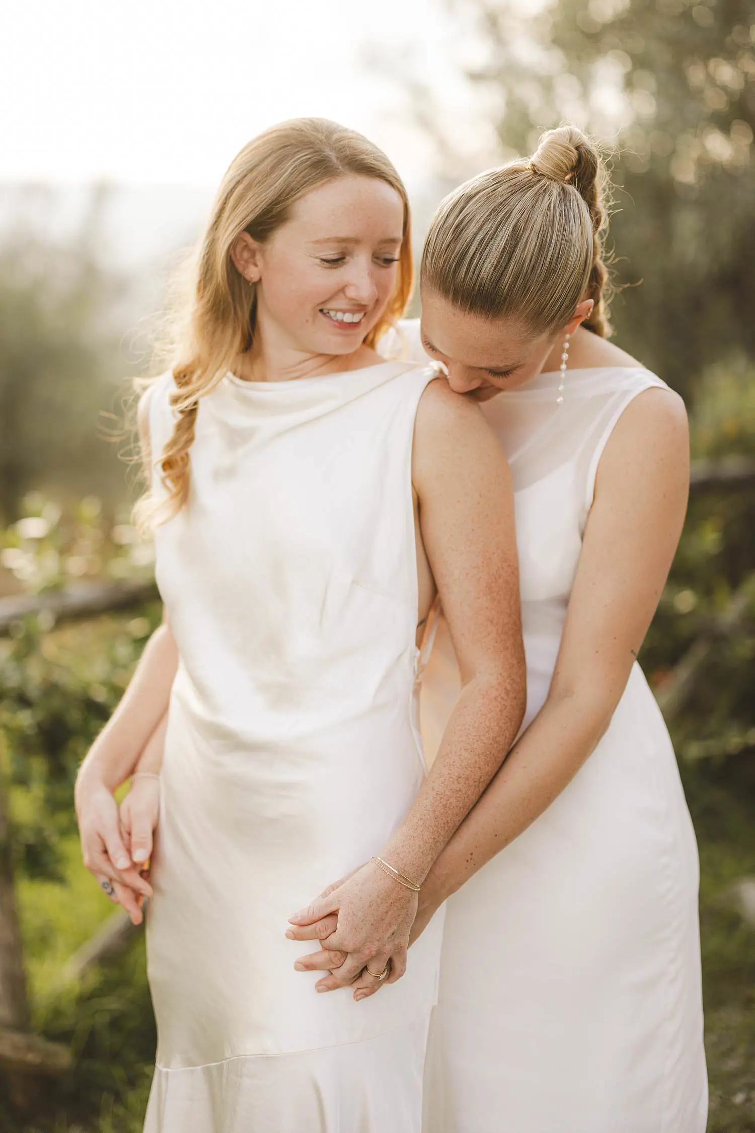 Same sex brides share natural and emotional joyful moment during portrait session at Borgo di Petrognano
