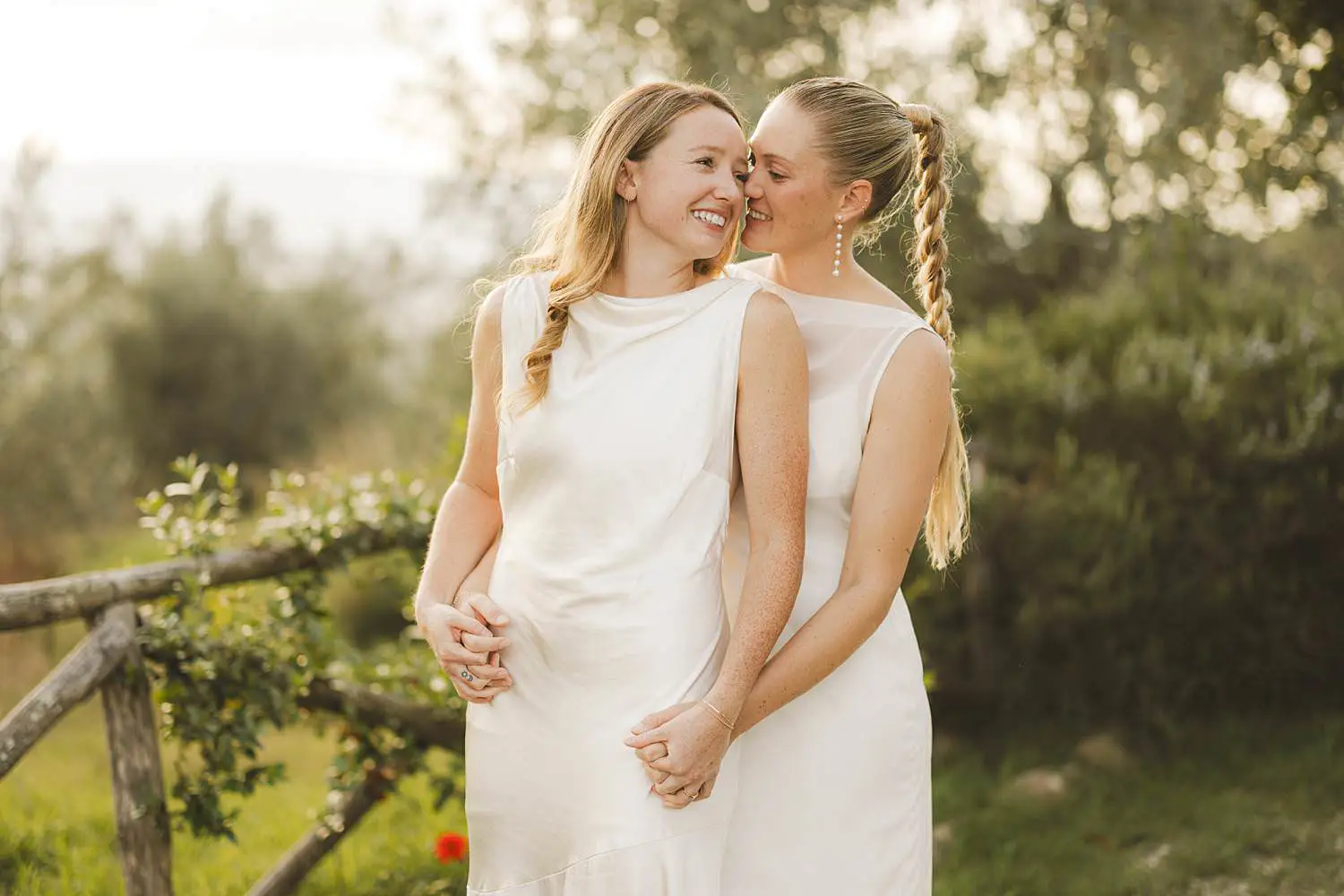 Same sex brides share natural and emotional joyful moment during portrait session at Borgo di Petrognano