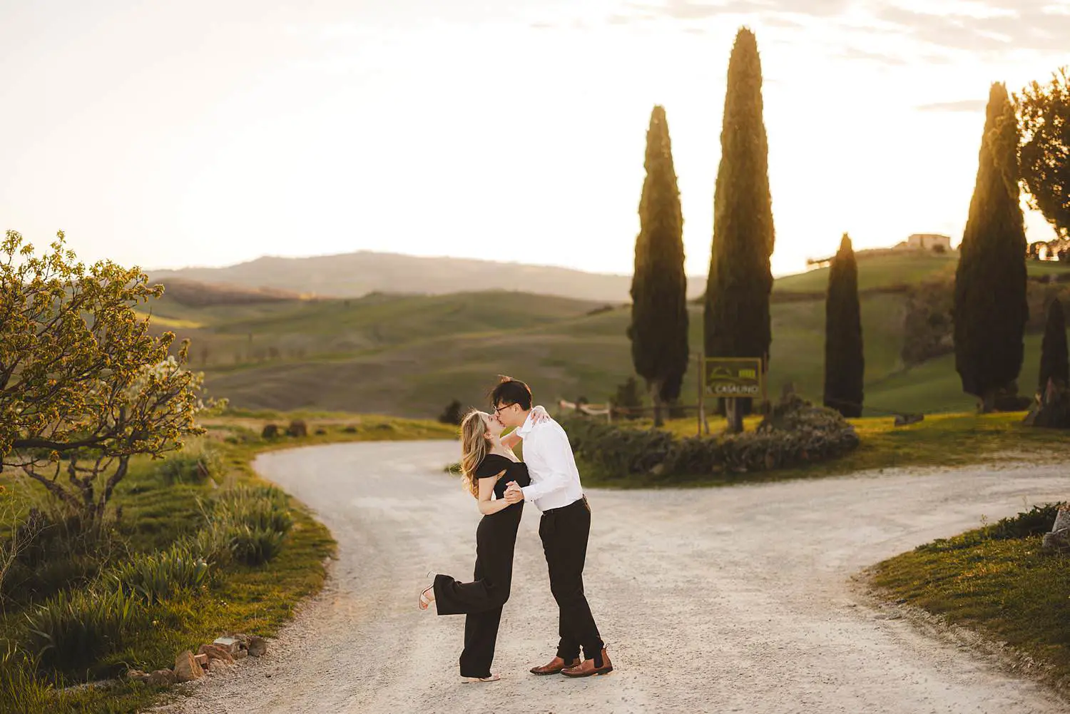 Elegant couple photo shoot in Tuscany countryside among evocative cypresses trees