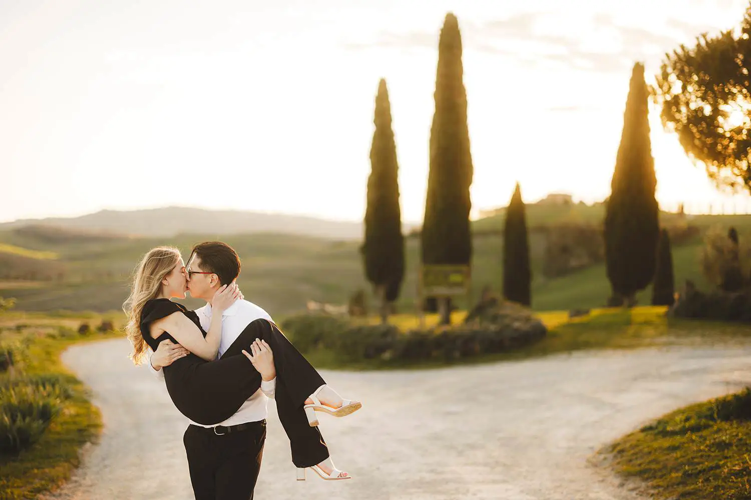 Elegant couple photo shoot in Tuscany countryside among evocative cypresses trees