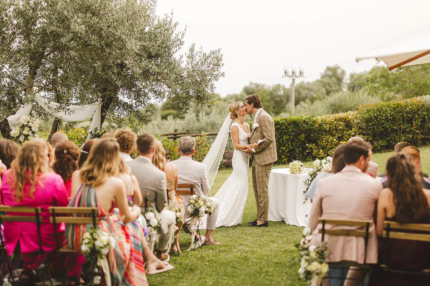 Bride and groom surrounded by the natural beauty of the Chianti landscape in the outdoor wedding ceremony at Quercia al Poggio