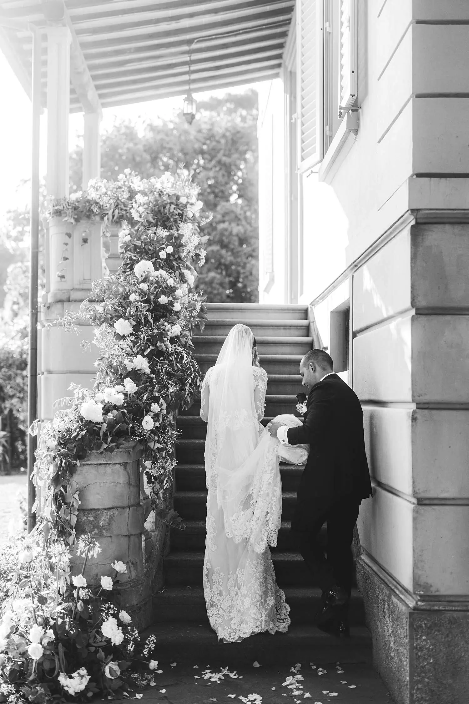 Bride and groom documentary portrait while walking into the main staircase of Villa Belvedere