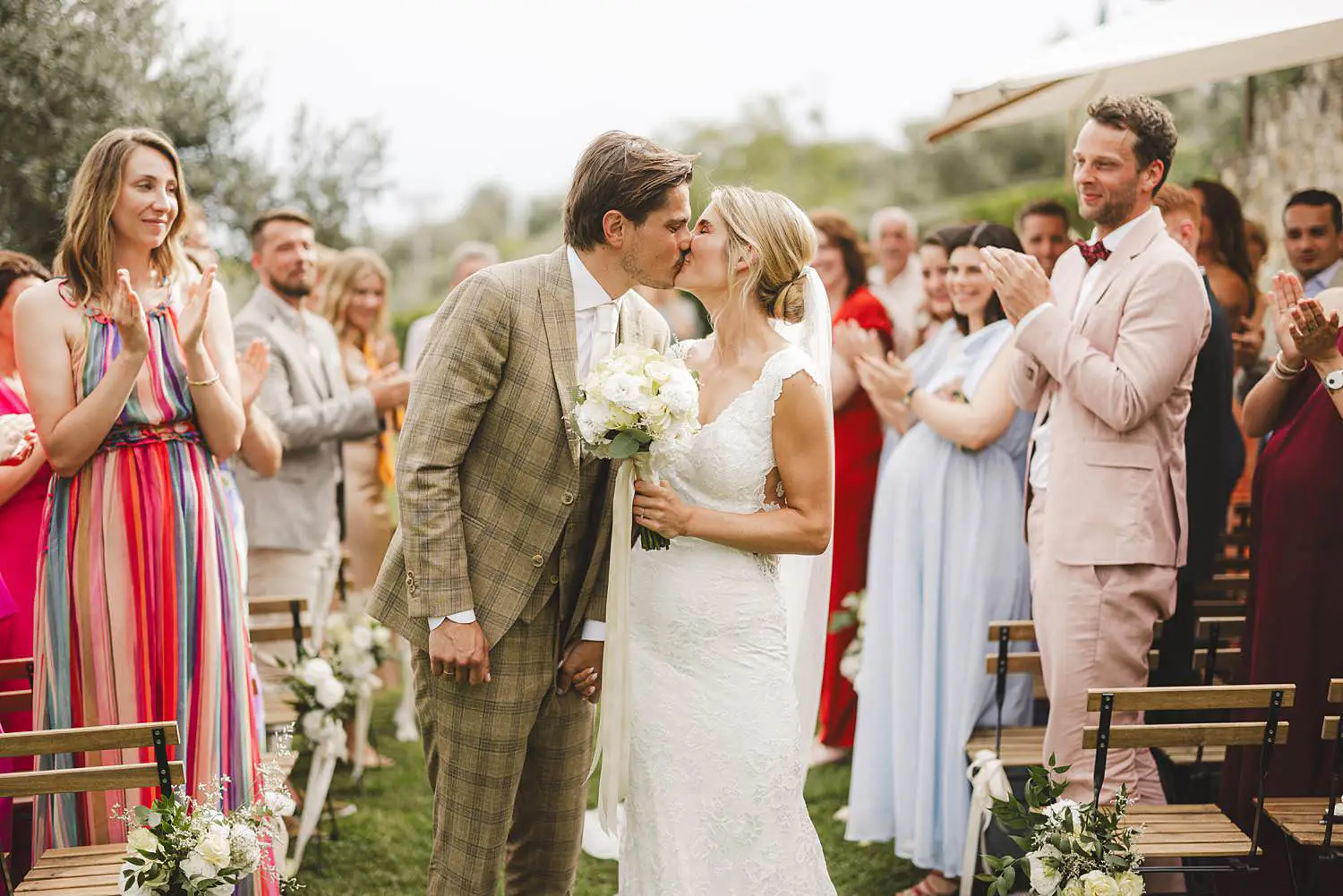 Bride and groom surrounded by the natural beauty of the Chianti landscape in the outdoor wedding ceremony at Quercia al Poggio