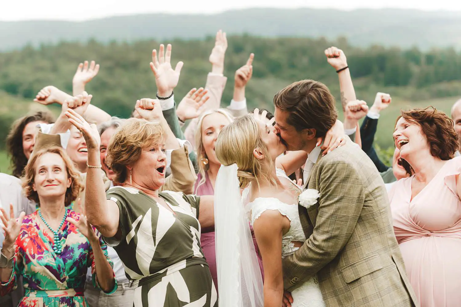 Bride and groom surrounded by friends, family and the natural beauty of the Chianti landscape at Quercia al Poggio