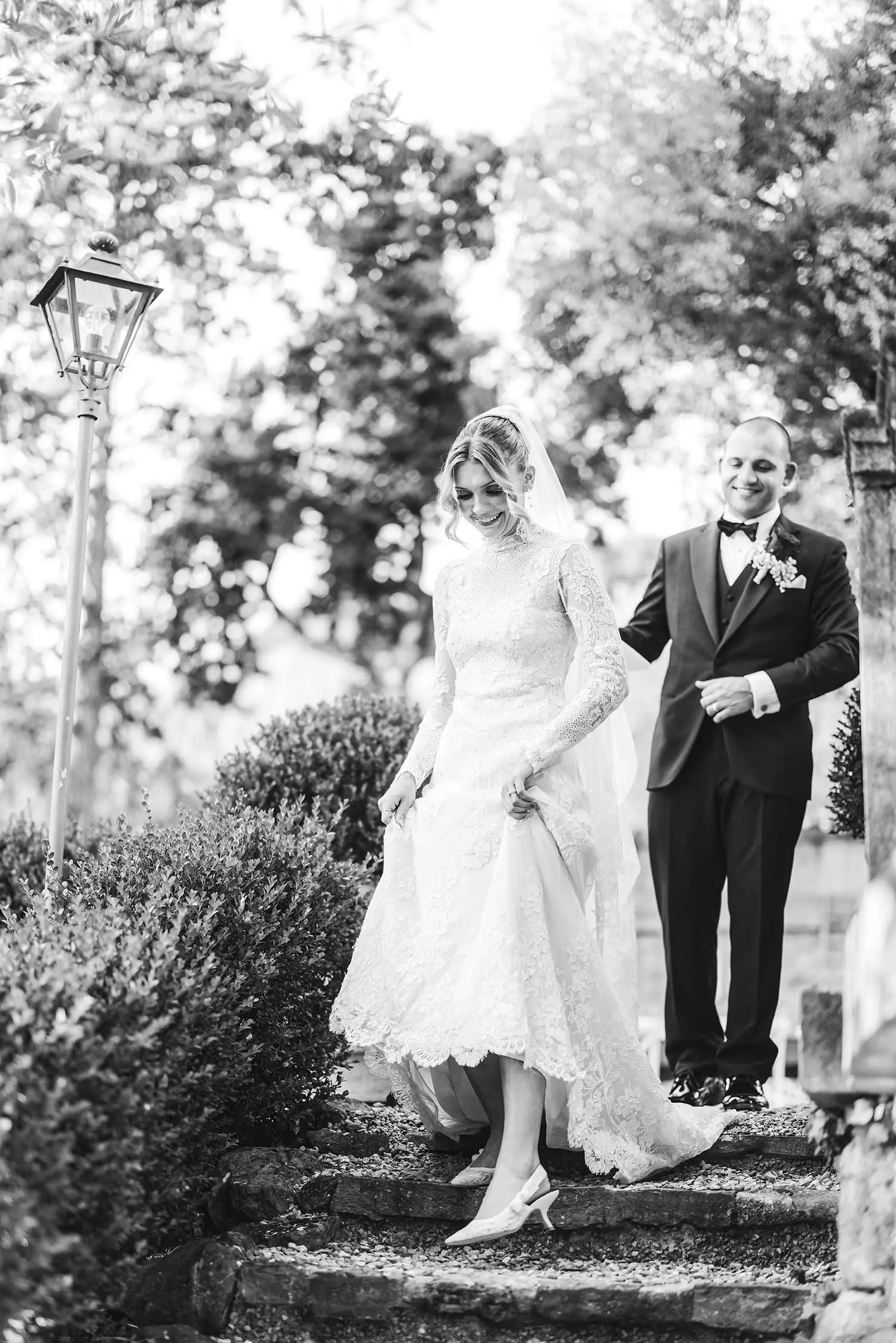 Bride and groom candid wedding photo while walking to the cocktail hour at Villa Belvedere in Loro CIuffenna