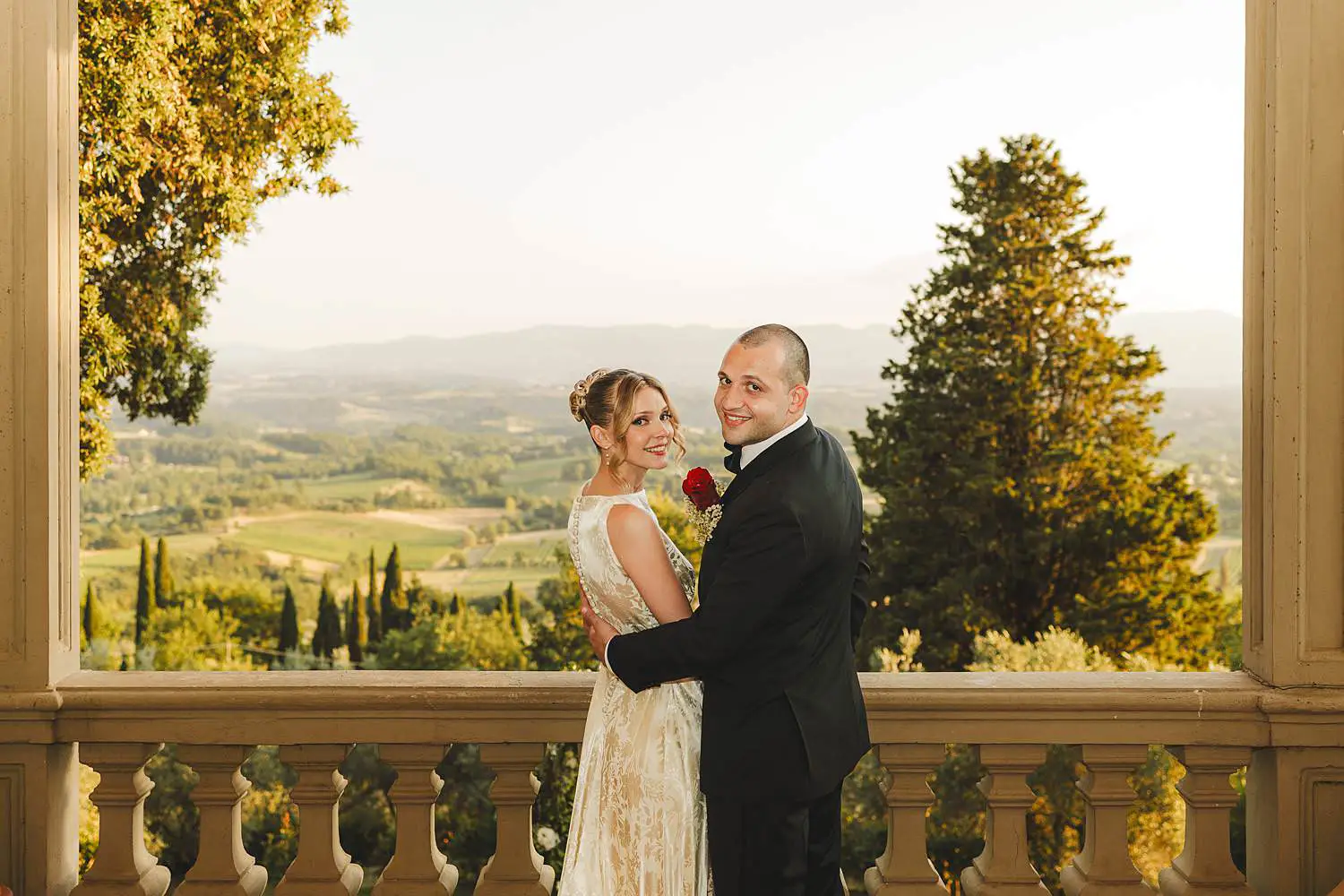 Bride and groom wedding photo while enjoying the view of Tuscany countryside at Villa Belvedere in Loro Ciuffenna