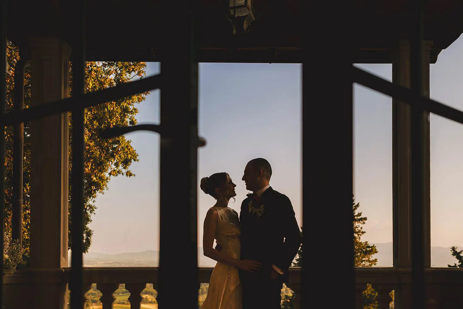 Bride and groom wedding photo while enjoying the view of Tuscany countryside at Villa Belvedere in Loro Ciuffenna