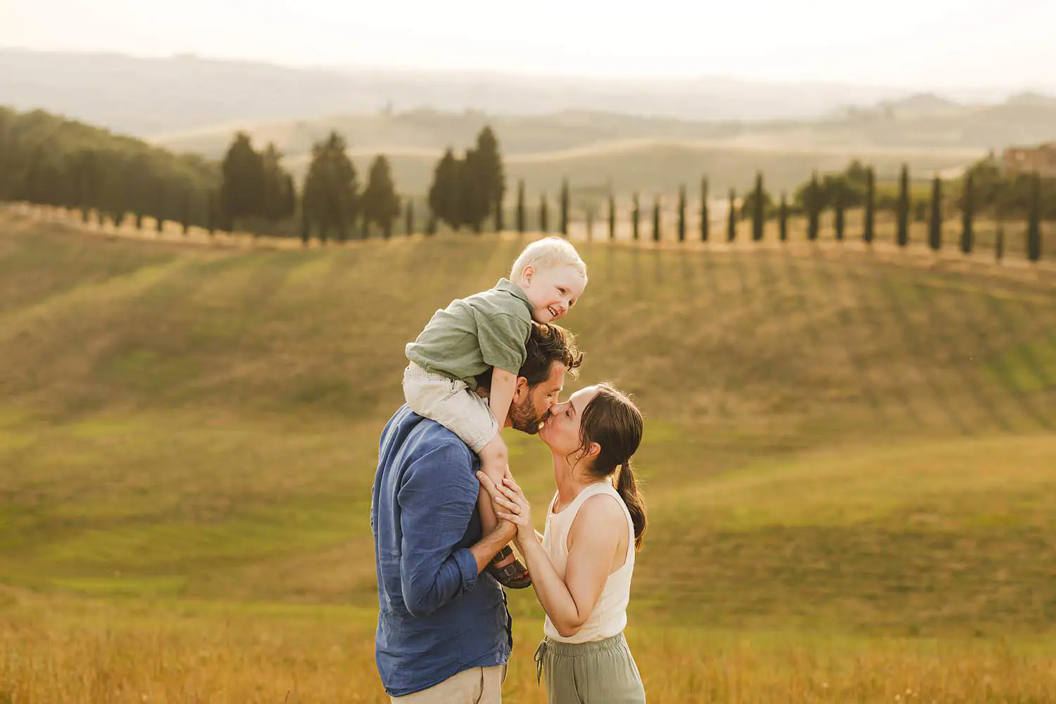 Sunset family photo shoot in iconic countryside of Tuscany near Certaldo with cypresses lined path trees