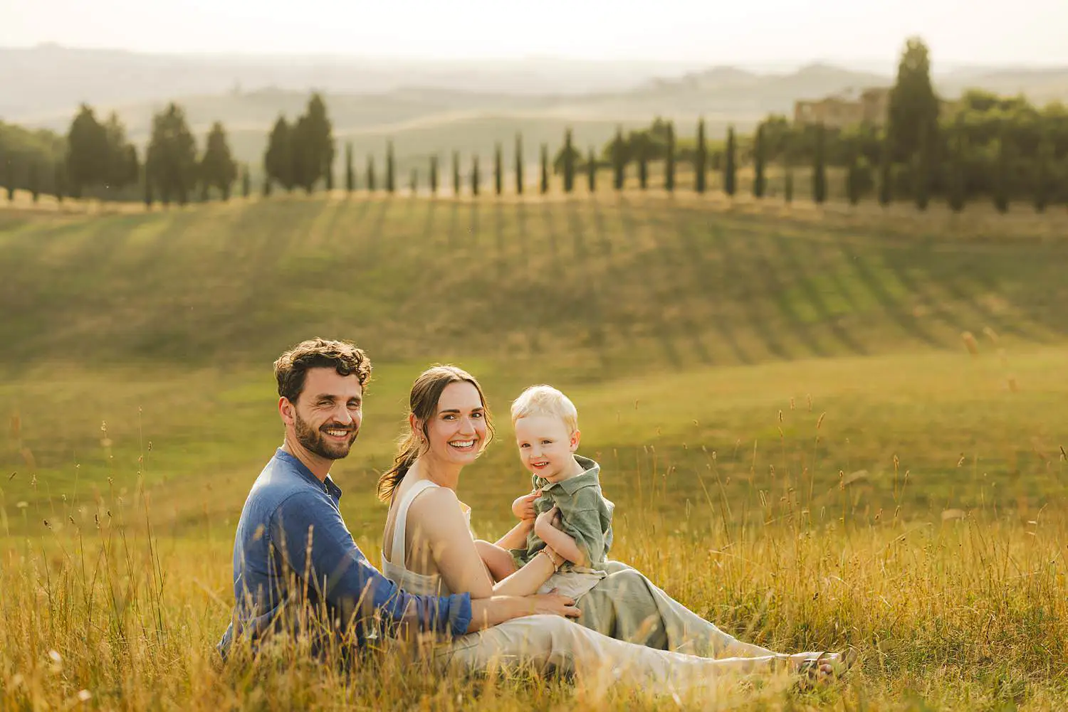 Sunset family photo shoot in iconic countryside of Tuscany near Certaldo with cypresses lined path trees