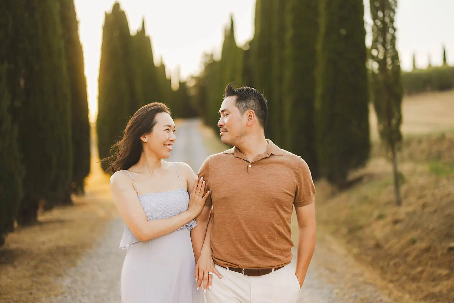 Dreaming and spontaneous engagement photos in the iconic cypresses avenue of the countryside near Pienza