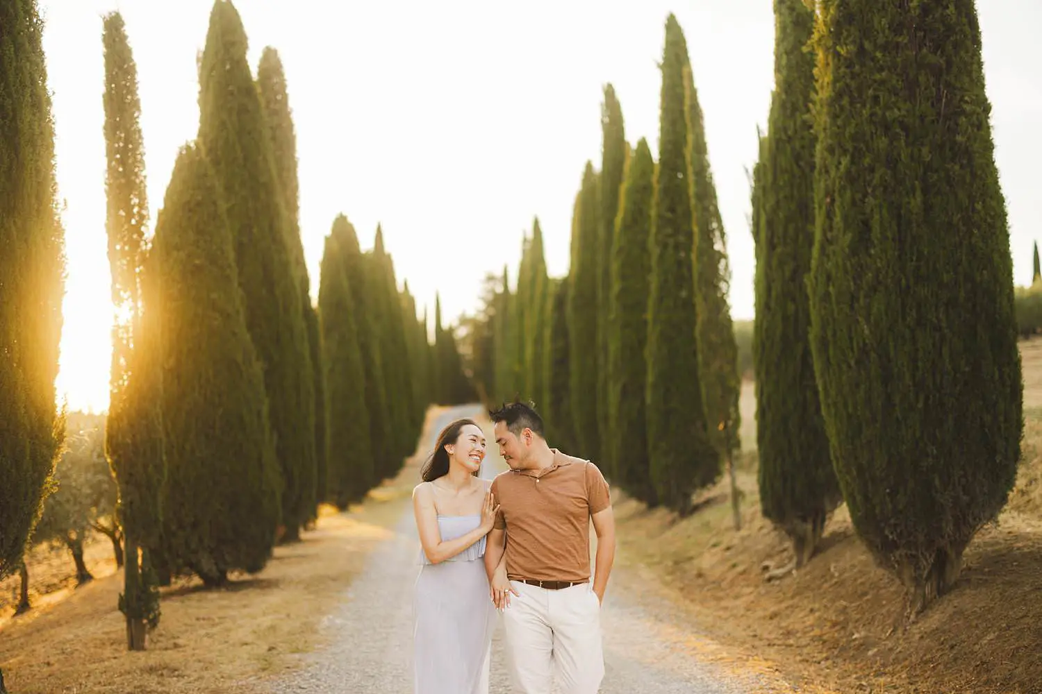 Dreaming and spontaneous engagement photos in the iconic cypresses avenue of the countryside near Pienza