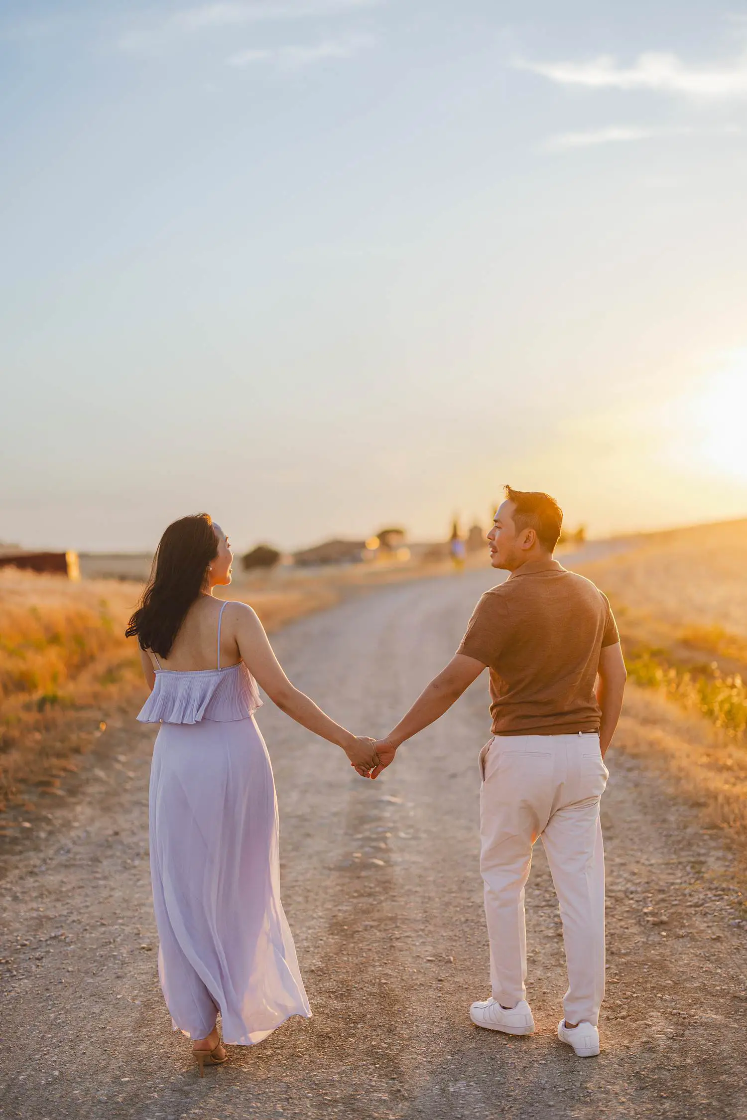 Spontaneous couple photo shoot under warm golden light near Vitaleta Chapel