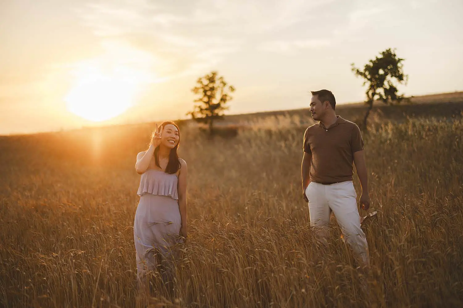 Exciting couple photo shoot under warm golden light near Vitaleta Chapel